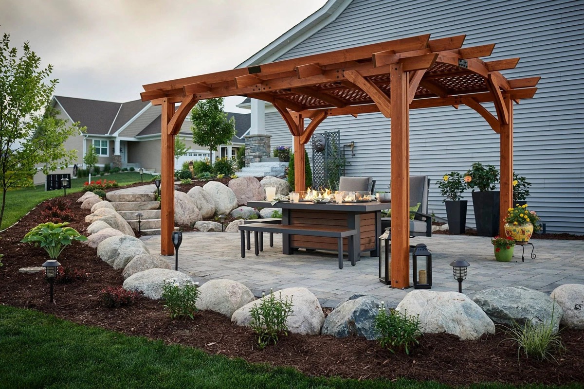 Pergola over a paver patio with boulder plantings